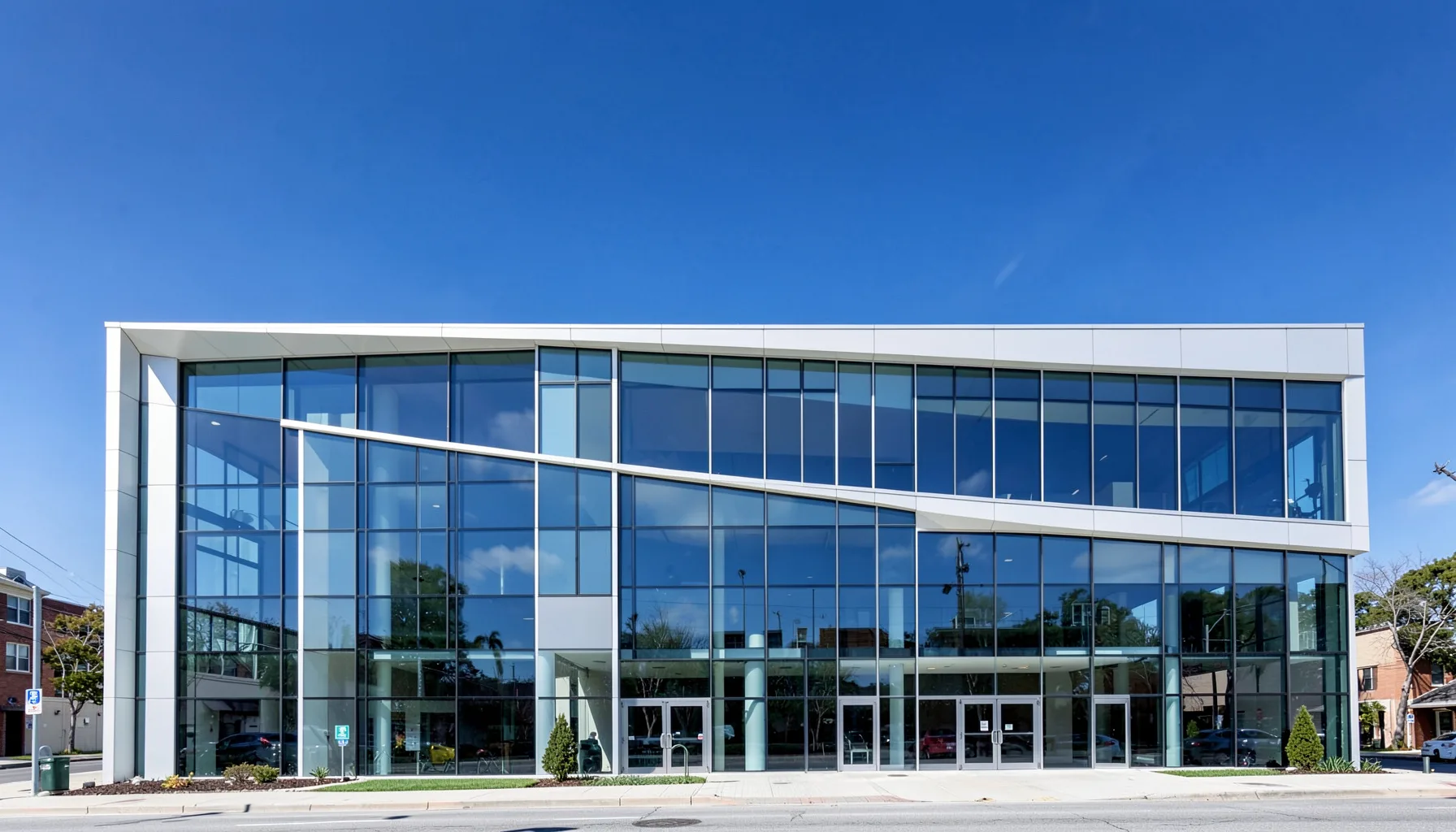 A modern university building facade with clean lines, glass panels, and a bright sky, navy and white tones